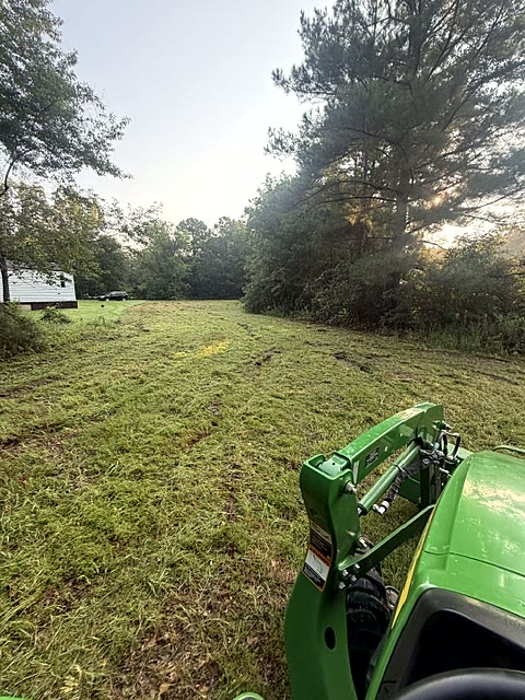 Bush hogging — Overgrown lot cut back